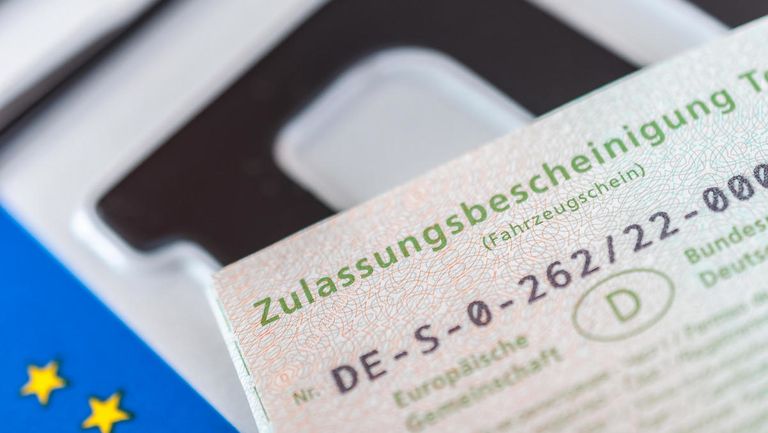 Symbolfoto: Nummernschild und Zulassungsbescheinigung